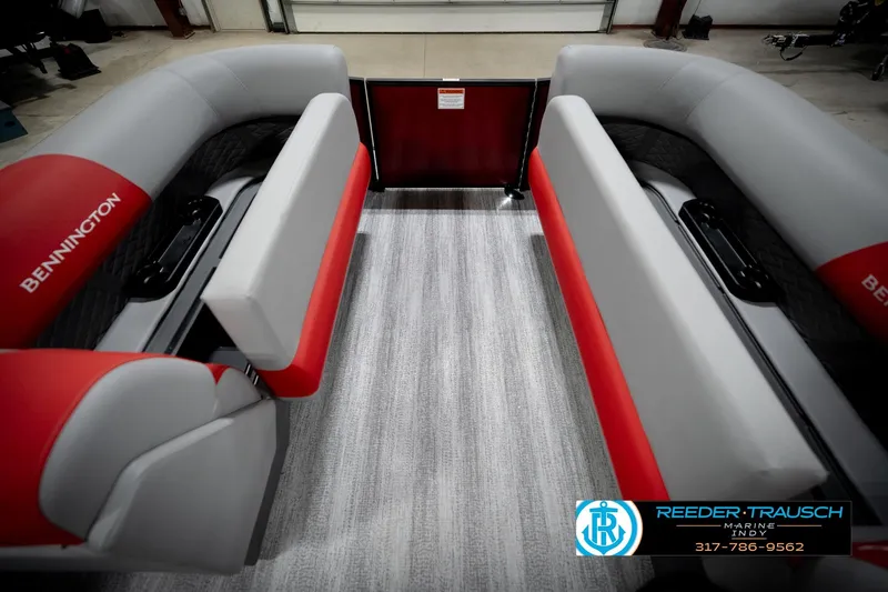 Slide: The Image of 2026 Bennington 22 SLJ boat interior with red and gray seating, showcased by Reeder-Trausch Marine. - 21