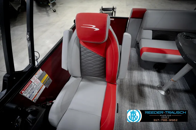 Slide: The Image of 2026 Bennington 22 SLJ boat interior with red and gray seating, Reeder-Trausch Marine logo. - 22