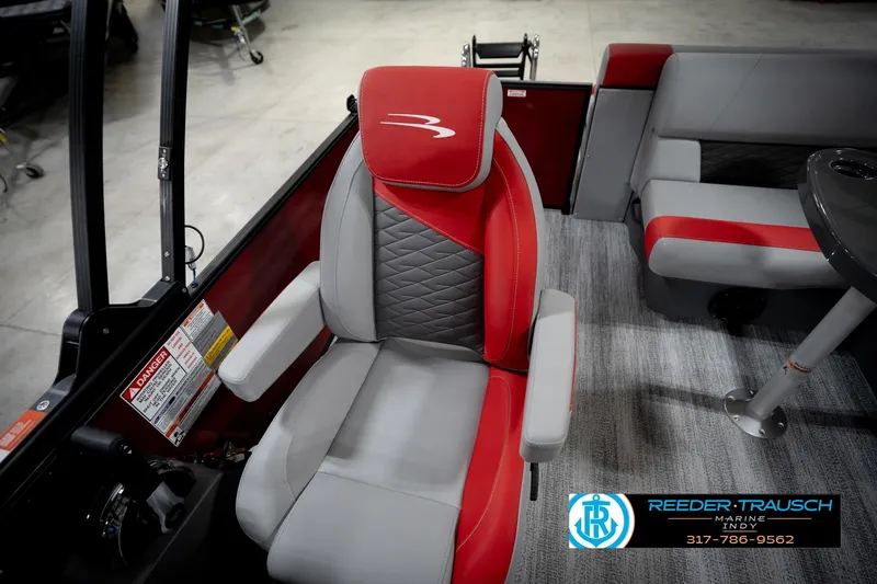 Slide: The Image of 2026 Bennington 22 SLJ boat interior with red and gray seating, Reeder-Trausch Marine logo. - 23