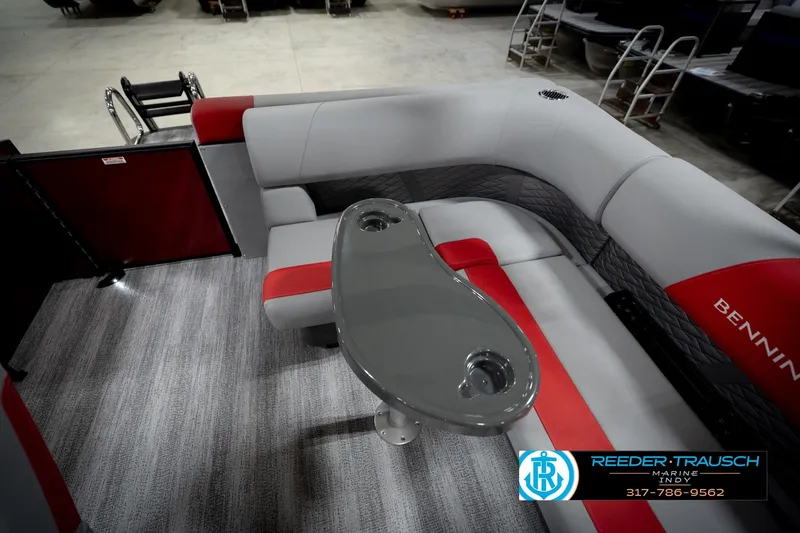 Slide: The Image of 2026 Bennington 22 SLJ boat interior with gray and red seating, featuring a sleek table. - 24