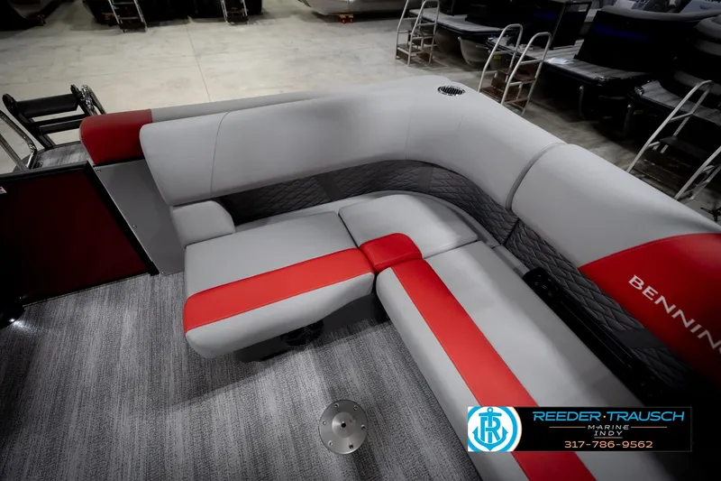 Slide: The Image of 2026 Bennington 22 SLJ boat interior with gray and red seating, showroom display. - 25