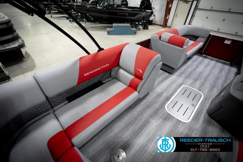 Slide: The Image of 2026 Bennington 22 SLJ boat interior with red and gray seating in showroom. - 27