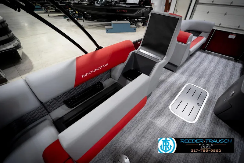 Slide: The Image of 2026 Bennington 22 SLJ pontoon boat interior with red and gray seating, open storage compartment. - 28