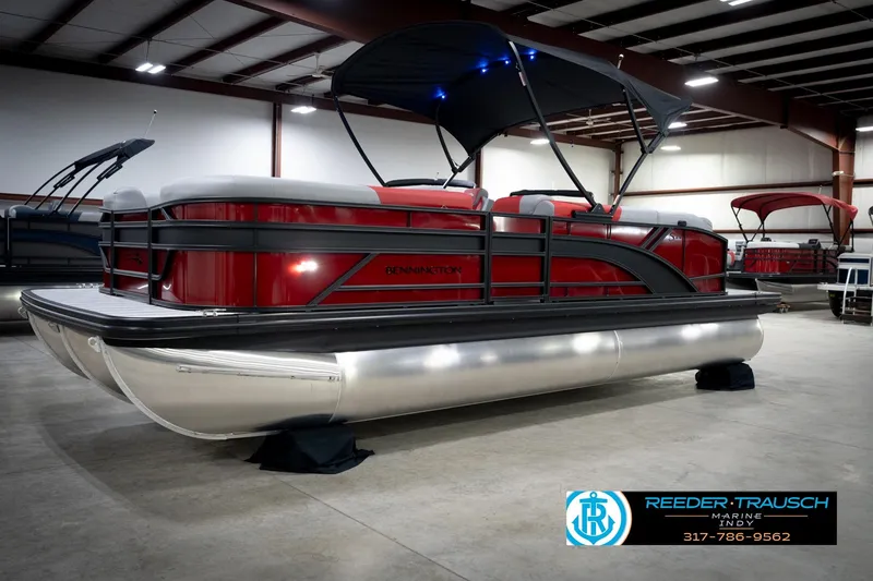 Slide: The Image of 2026 Bennington 22 SLJ pontoon boat in showroom, featuring sleek red design and canopy. - 3