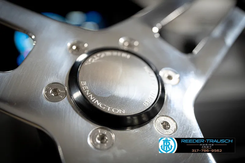 Slide: The Image of Close-up of 2026 Bennington 22 SLJ steering wheel with logo, featuring sleek metallic design. - 31