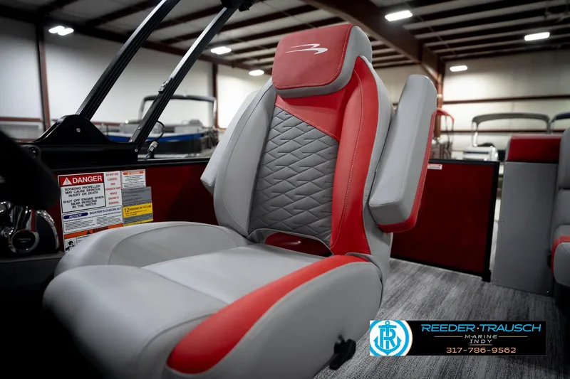 Slide: The Image of 2026 Bennington 22 SLJ boat interior with red and gray seating in showroom. - 38