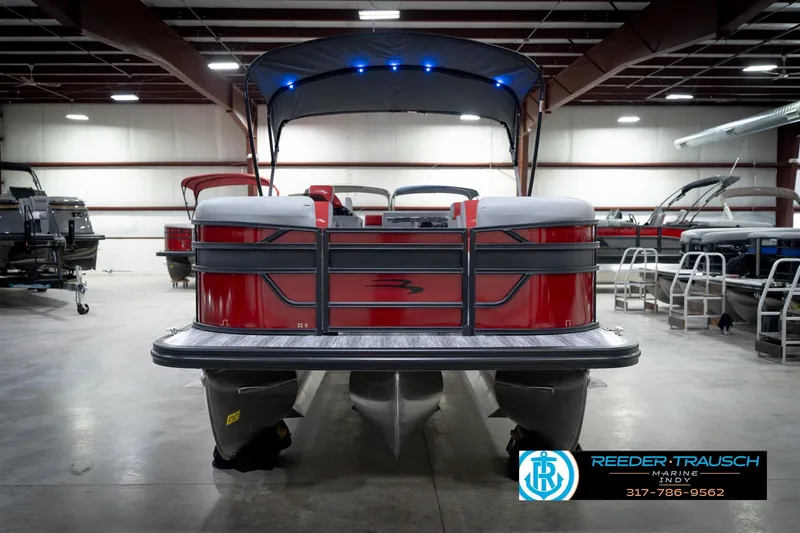 Slide: The Image of 2026 Bennington 22 SLJ pontoon boat in showroom, featuring red and gray design. - 4