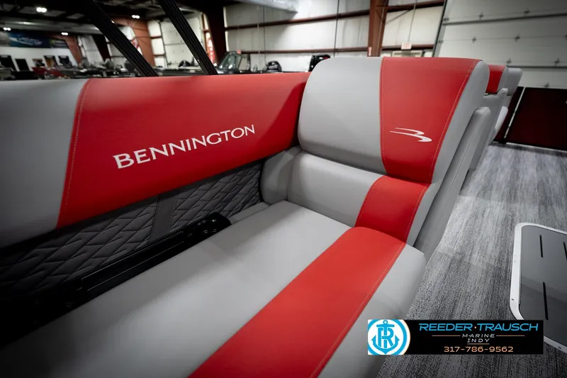 Slide: The Image of 2026 Bennington 22 SLJ boat interior with red and gray seating in showroom. - 40