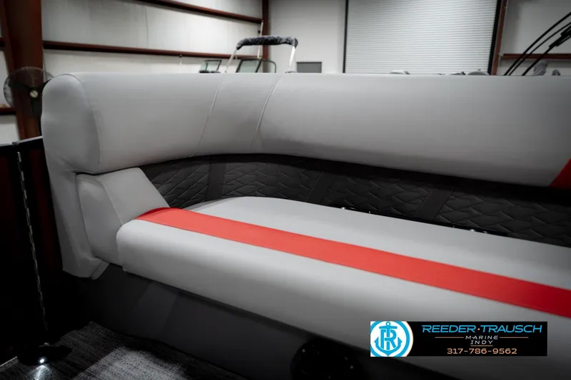 Slide: The Image of 2026 Bennington 22 SLJ boat interior with gray and red seating, Reeder-Trausch Marine logo. - 43