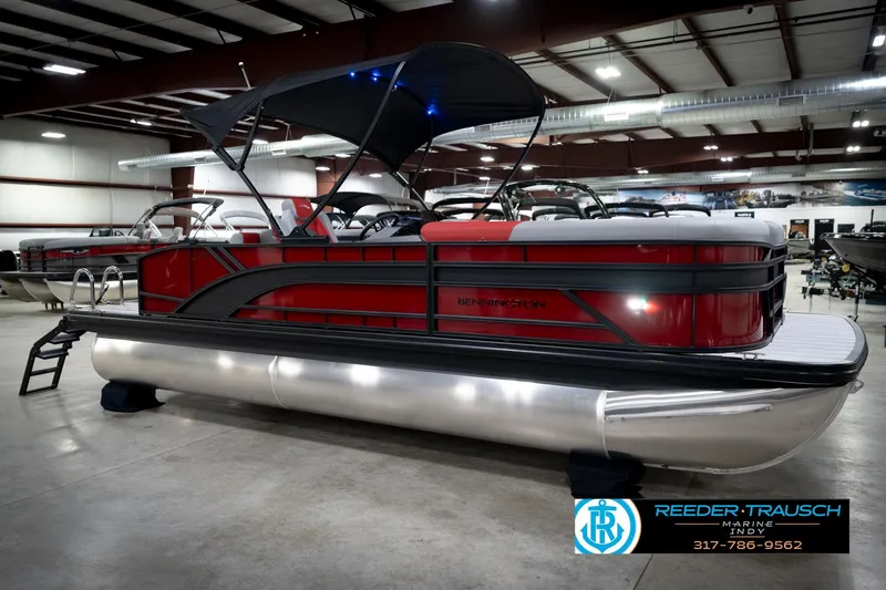 Slide: The Image of 2026 Bennington 22 SLJ pontoon boat in showroom with canopy and sleek design. - 5