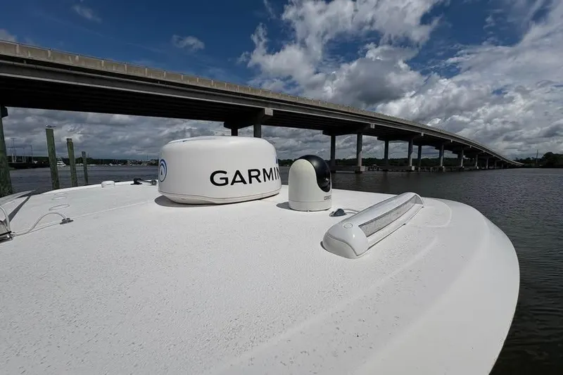 Slide: The Image of 2021 Seahunt 255 Ultra boat with Garmin equipment near a bridge under cloudy sky. - 10
