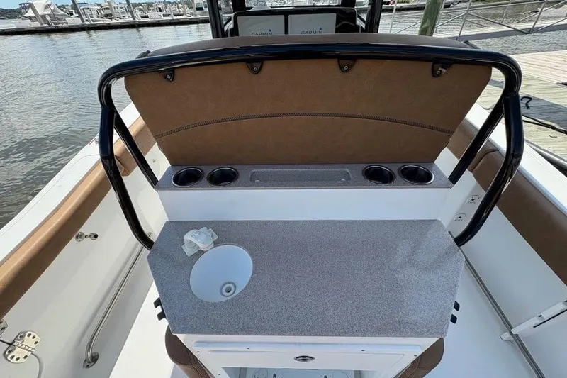 Slide: The Image of 2021 Seahunt 255 Ultra boat interior with sink and cup holders at marina. - 14