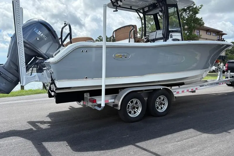 Slide: The Image of 2021 Seahunt 255 Ultra boat on trailer with Yamaha engine, parked on road. - 3