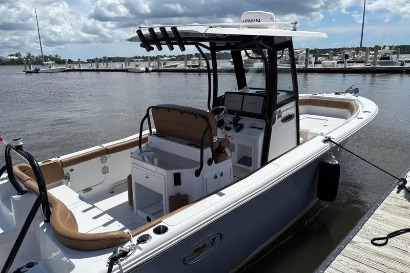 Slide: The Image of 2021 Seahunt 255 Ultra boat docked at marina under cloudy sky. - 5