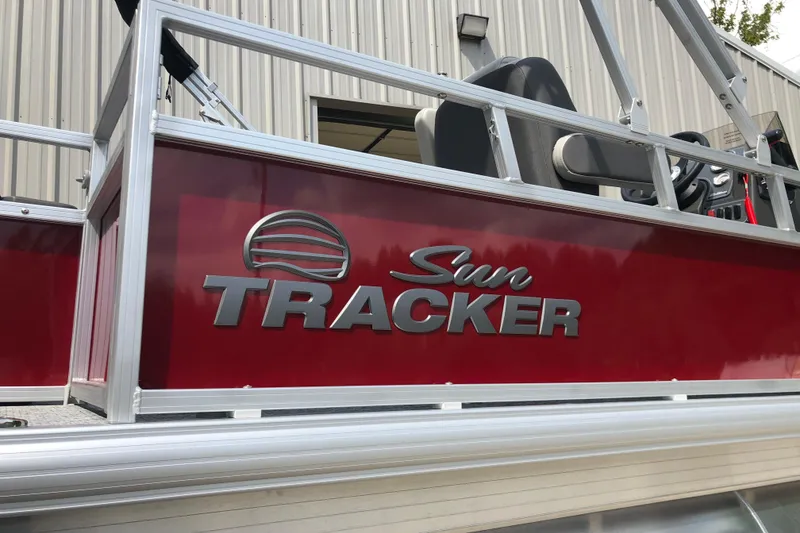 Slide: The Image of 2026 Sun Tracker Bass Buggy 18 DLX pontoon boat with red and silver detailing. - 18