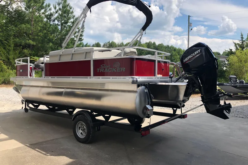 Slide: The Image of 2026 Sun Tracker Bass Buggy 18 DLX pontoon boat with Mercury outboard motor. - 2