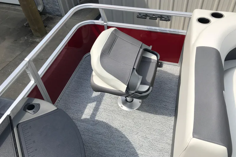 Slide: The Image of 2026 Sun Tracker Bass Buggy 18 DLX boat interior with swivel seat and cup holders. - 8