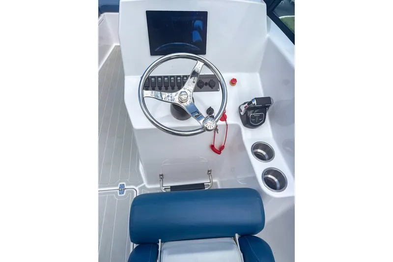 Slide: The Image of 2024 Aquasport AS DC 22 boat dashboard with steering wheel and controls. - 10