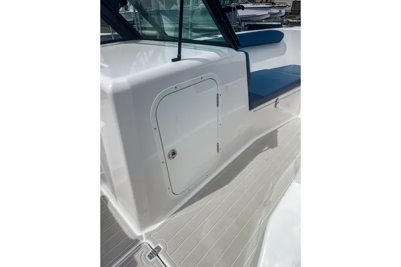 Slide: The Image of 2024 Aquasport AS DC 22 boat interior with white deck and blue seating. - 16