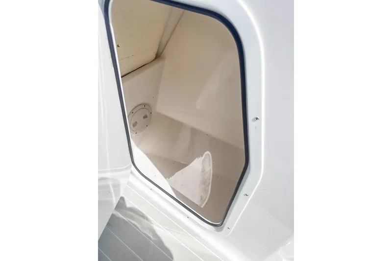 Slide: The Image of 2024 Aquasport AS DC 22 boat storage compartment, white interior, open hatch. - 20