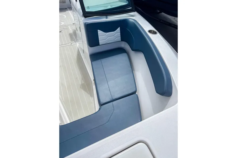Slide: The Image of 2024 Aquasport AS DC 22 boat interior with blue cushioned seating and sleek design. - 22
