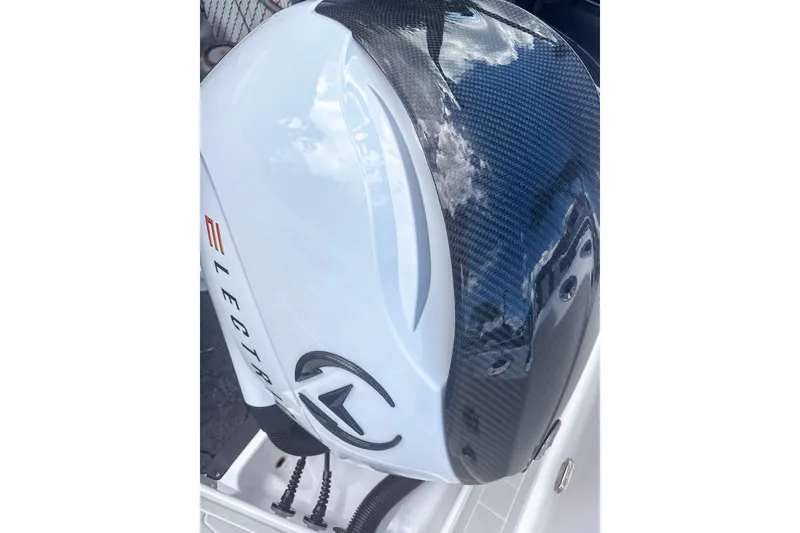 Slide: The Image of 2024 Aquasport AS DC 22 outboard motor with sleek carbon fiber finish. - 26