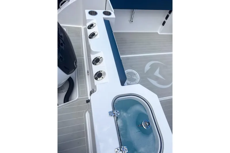 Slide: The Image of 2024 Aquasport AS DC 22 boat interior with rod holders and livewell. - 7