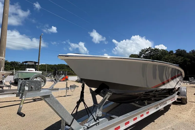 Slide: The Image of 2025 Legend race boat on trailer under clear blue sky. - 6