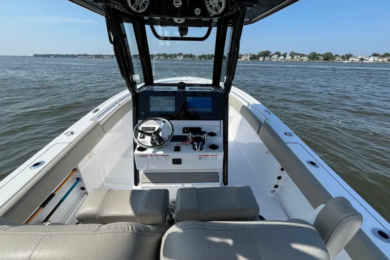 Slide: The Image of 2024 Sportsman Open 252 Center Console boat interior on calm water. - 15