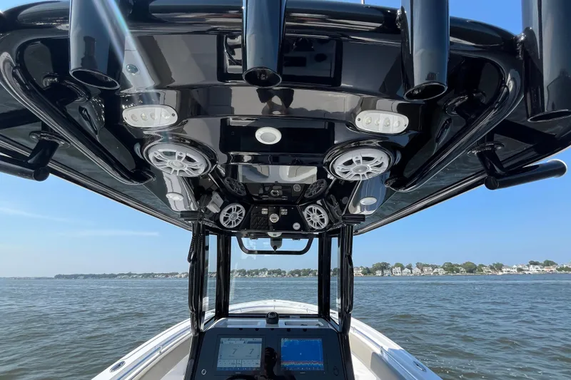 Slide: The Image of 2024 Sportsman Open 252 Center Console boat interior with advanced controls and ocean view. - 17