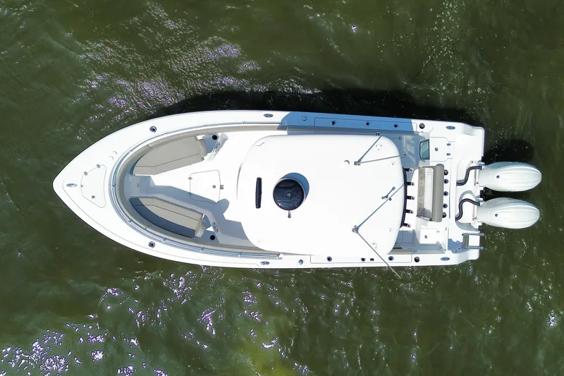 Slide: The Image of 2024 Sportsman Open 252 Center Console boat on water, aerial view. - 24