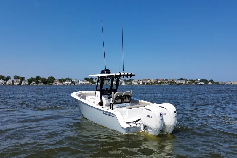 Slide: The Image of 2024 Sportsman Open 252 Center Console boat on water with dual Yamaha engines. - 3
