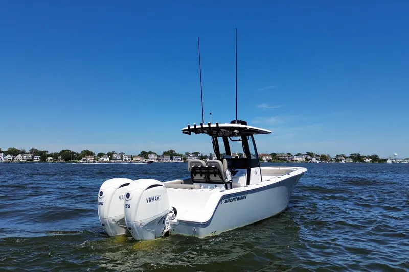 Slide: The Image of 2024 Sportsman Open 252 Center Console boat on water with dual Yamaha engines. - 4
