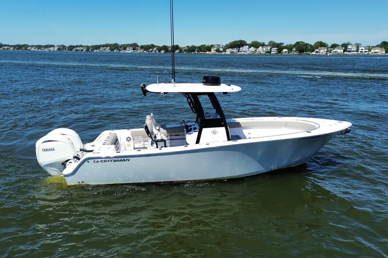 Slide: The Image of 2024 Sportsman Open 252 Center Console boat on calm water with Yamaha engine. - 5