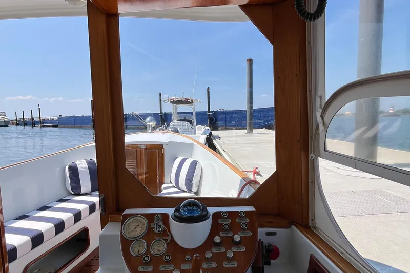Slide: The Image of Interior view of a 2002 Duffy Electric 30 boat docked at a marina. - 10