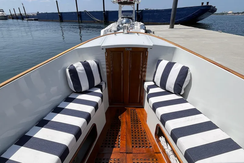 Slide: The Image of Interior of 2002 Duffy Electric 30 boat with striped seating and wooden flooring. - 11