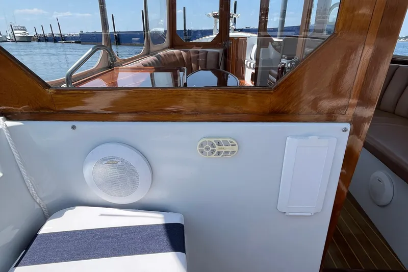 Slide: The Image of Interior of 2002 Duffy Electric 30 boat with wood accents and seating. - 12