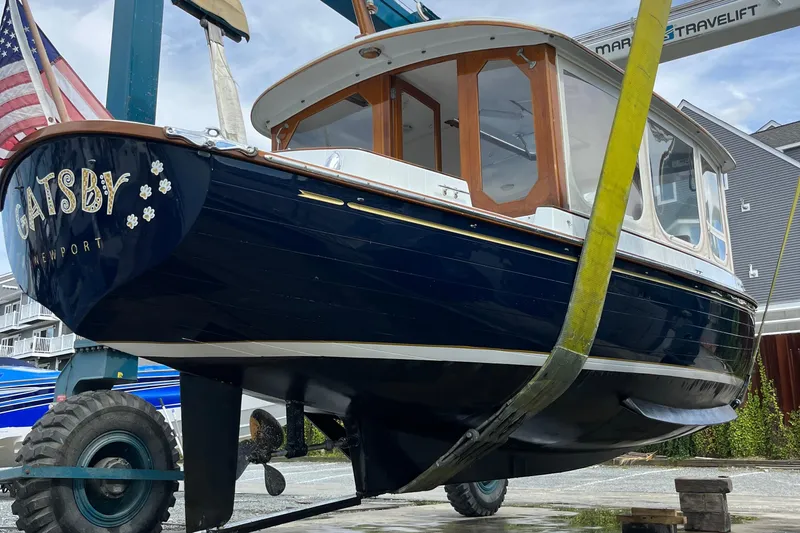Slide: The Image of 2002 Duffy Electric 30 boat named "Gatsby" in a boatyard lift. - 19