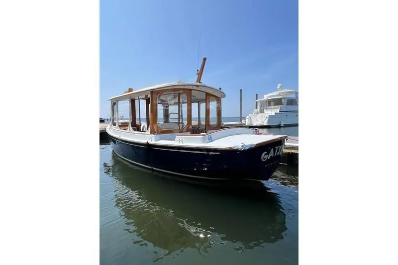 Slide: The Image of 2002 Duffy Electric 30 boat docked in marina under clear blue sky. - 2