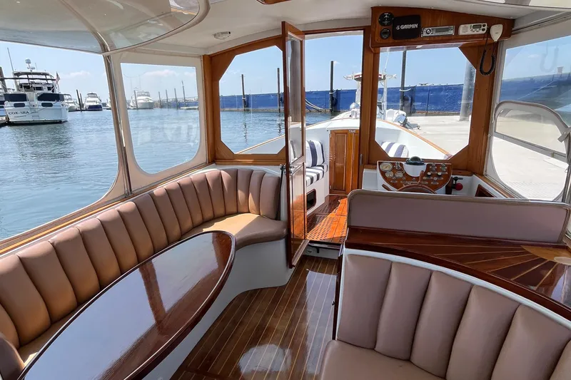 Slide: The Image of Interior of a 2002 Duffy Electric 30 boat with elegant seating and wood accents. - 4
