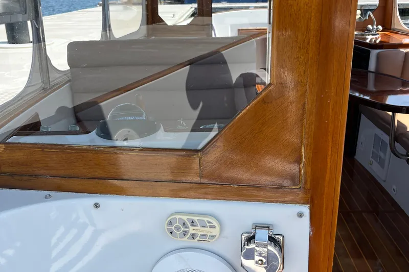 Slide: The Image of 2002 Duffy Electric 30 boat interior with wooden accents and control panel. - 6