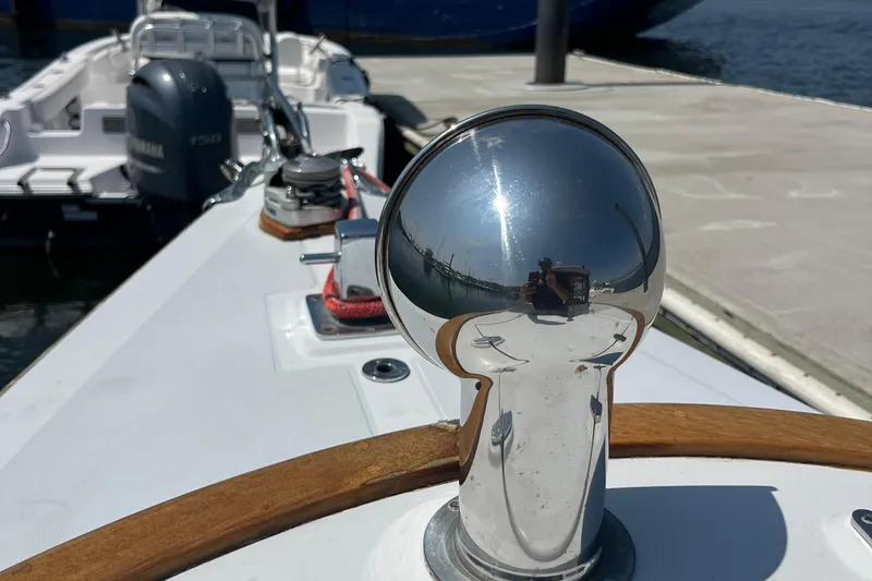 Slide: The Image of Polished metal detail on 2002 Duffy Electric 30 boat, docked with reflections. - 7