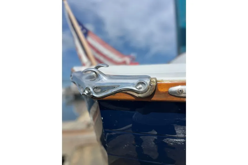 Slide: The Image of Close-up of a 2002 Duffy 30 boat's polished metal cleat with American flag in background. - 9