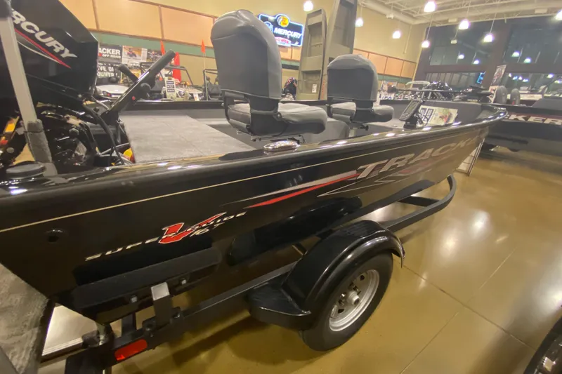 Slide: The Image of 2025 Tracker Super Guide V-16 T boat displayed indoors on a trailer. - 4