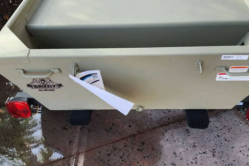 Slide: The Image of 2026 Tracker Grizzly 10 Jon boat rear view with logo and taillights. - 3