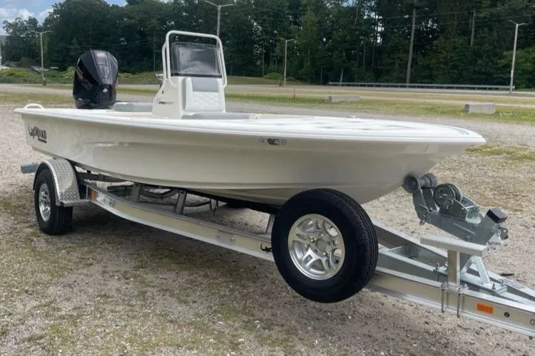 Slide: The Image of 2026 Mako 18 Pro Skiff boat on trailer, parked outdoors. - 3