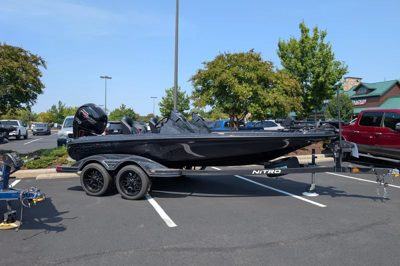 The Image of 2026 Nitro Z18 Pro boat on trailer in parking lot, side view. - 0