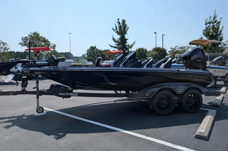 Slide: The Image of 2026 Nitro Z18 Pro boat in parking lot, sleek black design, dual axle trailer. - 5