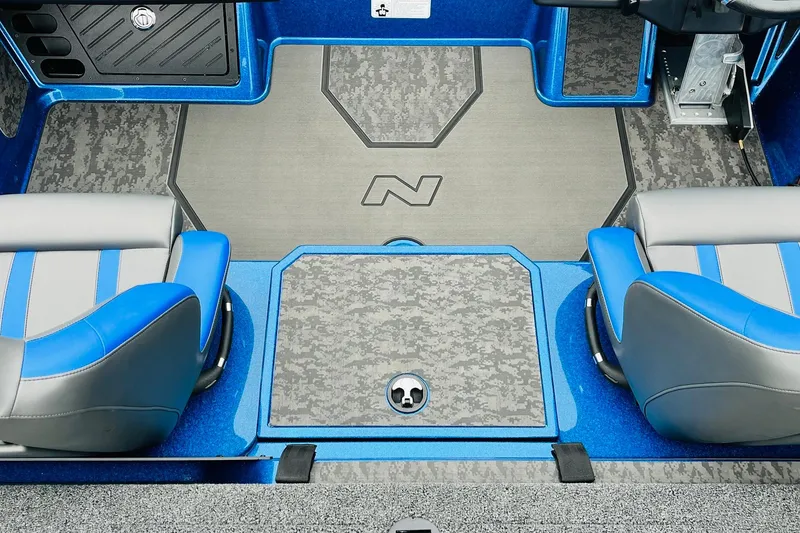 Slide: The Image of 2026 Nitro Z21 XL Pro boat interior with blue and gray seating and camo-patterned flooring. - 104