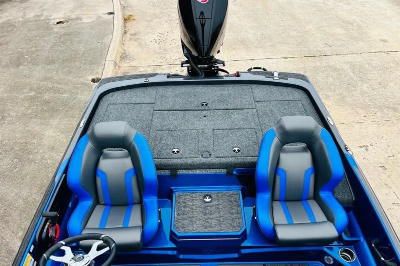 Slide: The Image of 2026 Nitro Z21 XL Pro boat interior with blue and gray seats, steering wheel visible. - 107